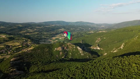 Side drone shot right to left of paraglider over Ozren cliffs near Sokobanja Stock Footage 328632358