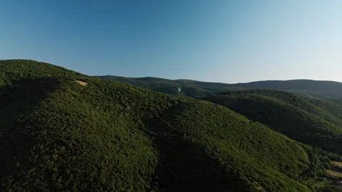Side drone shot right to left of paraglider over Ozren Mountain near Sokobanja Stock Footage 328635641