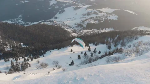 Side Drone Shot Of Tandem Paraglide Over Snow Covered Mountains With Peak Vídeo Stock 149201411