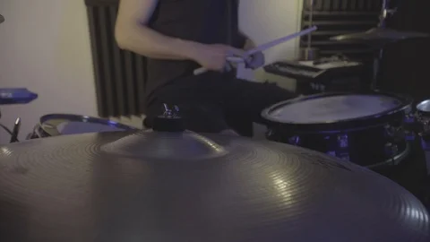 Side drum view of ride cymbals while drummer playing along Stockbeeldmateriaal 129097939