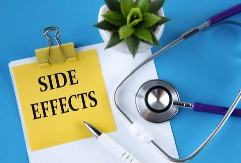 SIDE EFFECTS - words on a yellow notebook on a blue background with a steth.. Stock Photos