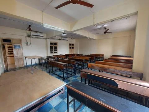 Side entry-view of college classroom with brown benches chairswhite marker board Stock Photos