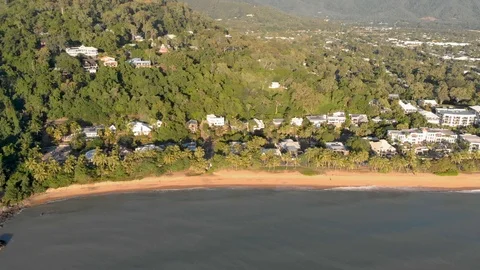 A side flight along a beach with luxury hotels and resorts at Sunrise, 4K Stock Footage 106725016