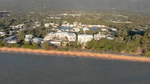 A side flight along a beach with luxury hotels and resorts at Sunrise, 4K Stock Footage 106778141