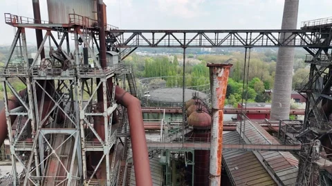 Side Flight Between Furnaces and Flowering Foreground Stock Footage 335378624
