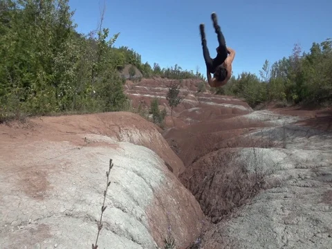 Side Flip Across Red Dirt Canyon Stock Footage 80072305