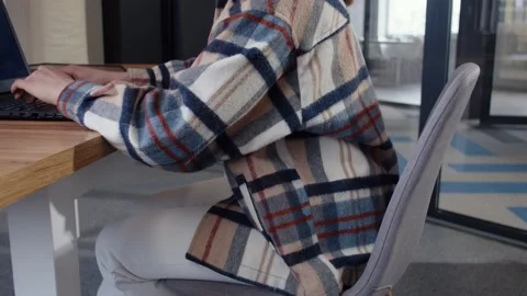 Side footage of young good-looking Ukrainian woman sitting at desk, using laptop Stock Footage 189039382