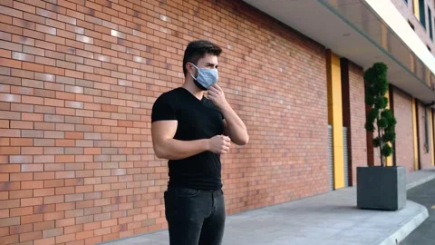 Side frame with a young man wearing a protective mask Stock Footage 140123488