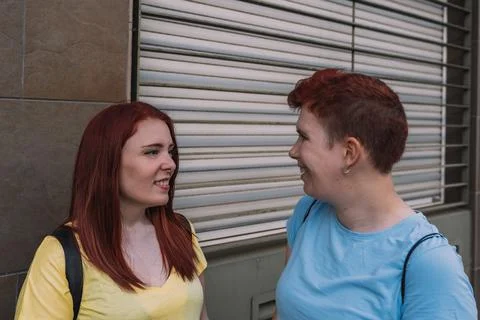 Side image of a cute and charming young women having a nice lively conversation Stock Photos