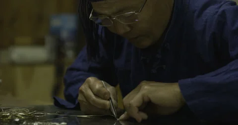 Side image,  tight image working on object on table Stock Footage 141358514