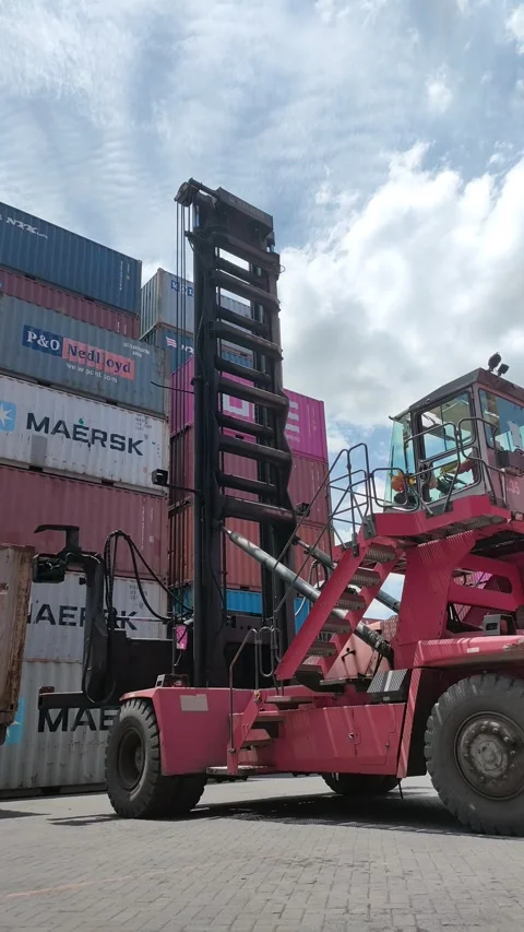 Side loader is carrying out the process of unloading and loading Stock Footage 296960792