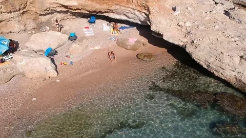 Side looking moving backwards from rocks to a turquoise sea Stock Footage 115214855