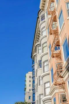 Side low angle view of adjacent apartments with emergency stairs at the front Stock Photos