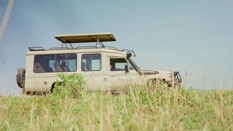 Side low angle view of special safari 4x4 truck with open roof for game viewing Stock Footage 304174473