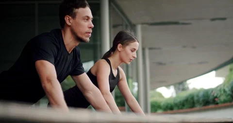 Side low shot of strong attractive two Caucasian person training push-ups Stock Footage 123661423