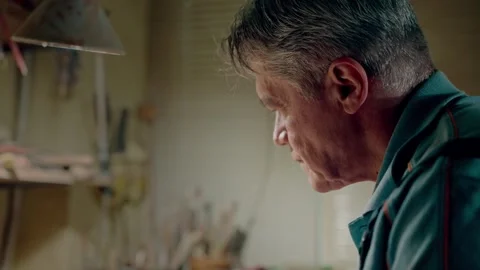 Side mid shot old man master of pottery doing his favorite job. Concentrated Stock Footage 263711441