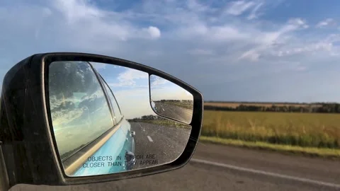 Side mirror of a car close-up. Car mirror with reflection of the road close-up Stock Footage 307935922