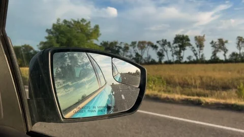 Side mirror of a car close-up. Car mirror with reflection of the road close-up Stock Footage 307935931