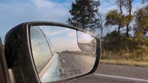 Side mirror of a car close-up. Car mirror with reflection of the road close-up Stock Footage 313754111