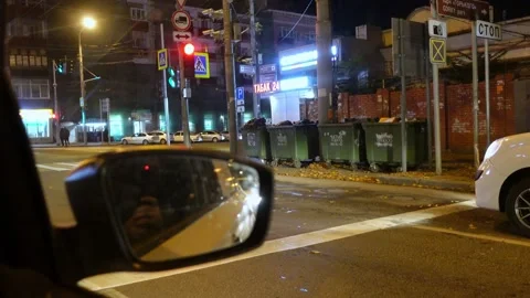 Side mirror of a car, standing at an intersection at red traffic light, view Stock Footage 160148555