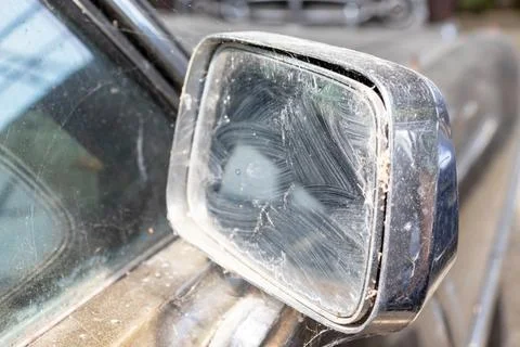 Side mirror of old abandoned rusty vehicles, crushed cars in scrapyard, junk Stock Photos