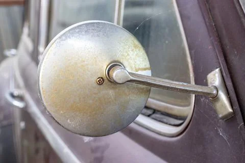 Side mirror of old abandoned rusty vehicles, crushed cars in scrapyard, junk  Stock Photos