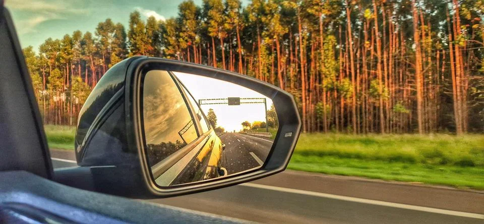 Side mirror reflection on the road Stock Photos