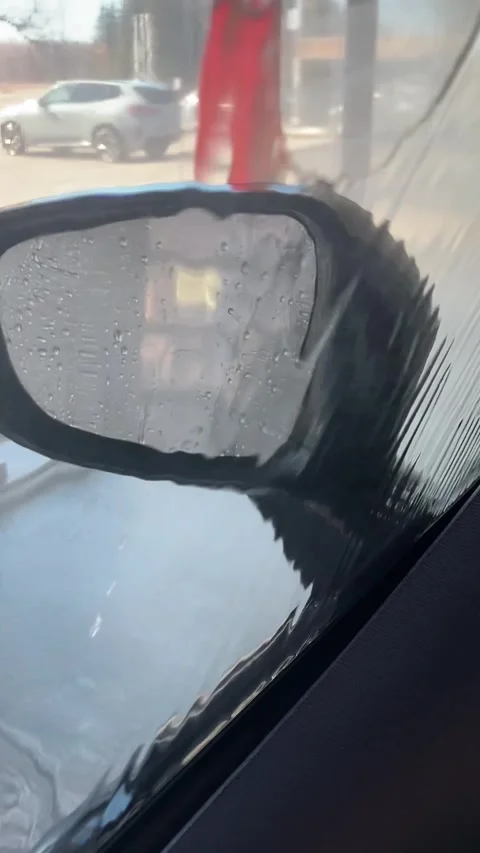Side mirror seen through window during car wash Stock-Footage 332412544