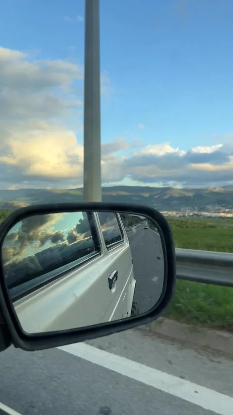 Side mirror shot of car during driving with scenic landscape Stock Footage 304879320