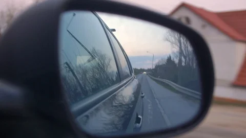 Side Mirror View of Car Driving by Trees and Houses Stock Footage 107416489