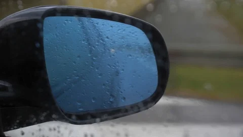 Side Mirror View of Car Driving in Heavy Rain Stock Footage 114686383