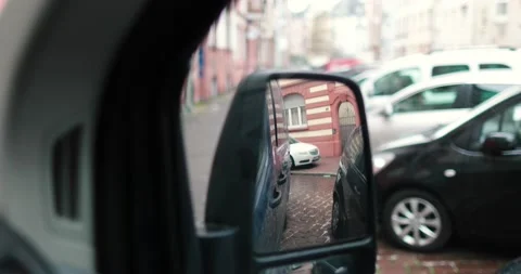 Side mirror view car driving by in van, city in germany, street video 4k Stock Footage 230486889