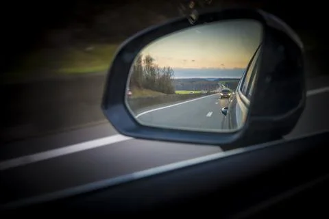 Side mirror view on the landscape and highway of E411, Autoroute des Ardenn.. Stock Photos