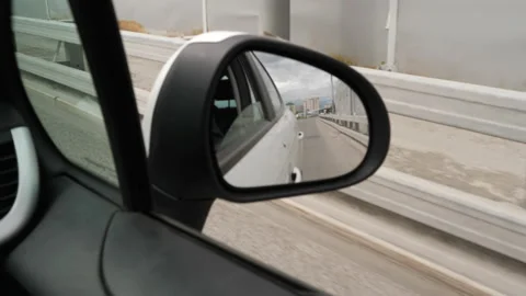 Side mirror view of a moving car Stock Footage 157116975