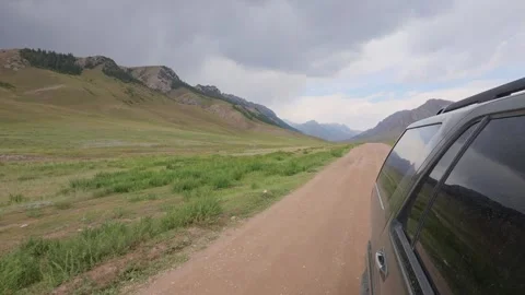 Side mounted camera on an SUV driving a steppe road, Naryn Region, Kyrgyzstan Stock Footage 347242761