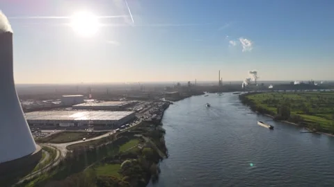 Side move revealing cooling tower and distant coking plant Stock Footage 331204759