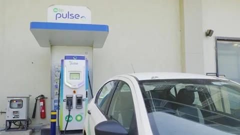 Side movement shot car charging at public DC fast charger from Jio BP Pulse with Stock Footage 333009456