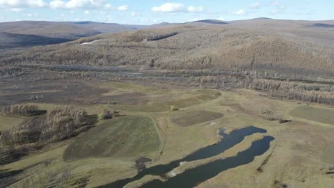 Side Moving Drone Over Autumn Forest and Winding Road Daxinganling China Stock Footage 330457261