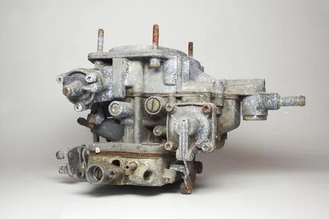 Side of old carburator for IC engine car with levers, adjusting screws, acc.. Stock Photos