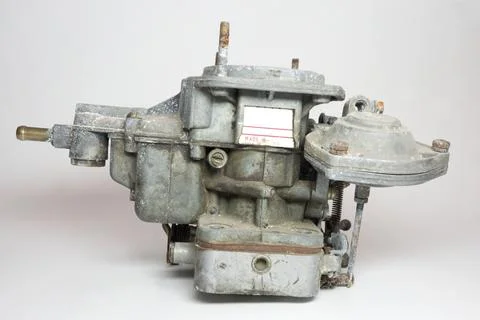Side of old carburator for IC engine car. Name plate, vacuum opening drive .. Stock Photos