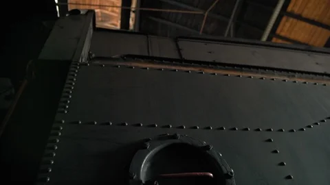 Side of an old steam train full of bolts and a hatch Stock Footage 107183540
