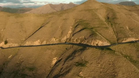 Side pan of car on sunny mountain road new zealand Stock Footage 133854955