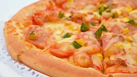 Side pan view fresh pizza with shrimps and bacon toppings close up Stock Footage 150079091