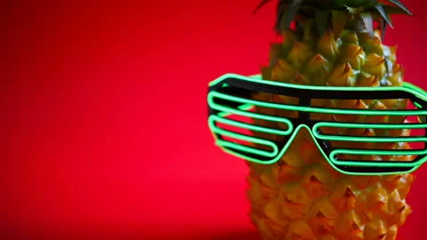 Side pan view pineapple wears a led glasses Stock Footage 147615698