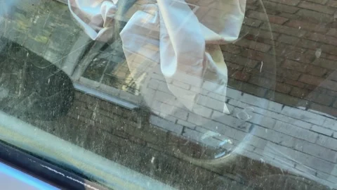 Side part of abandoned car, deployed airbag through dirty window Stock Footage 259971040