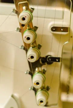 Side part of sewing machine, knobs to pass the thread. Various colors Foto stock