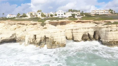 Side pass of white cavy cliff, water surface angle Stock Footage 125948939