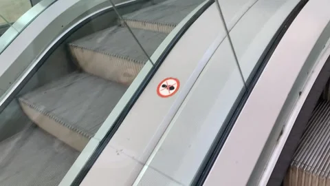 Side perspective of escalator steps in constant upward motion. Smooth Stock Footage 313938457