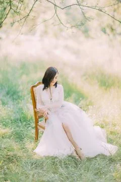 The side portrait of the woman in the long white dress looking at the left side Stock Photos
