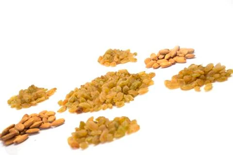 Side pose of different almonds heap and raisins heap Stock Photos
